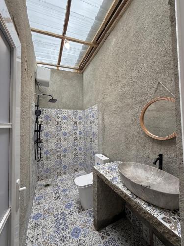 a bathroom with a sink and a toilet at Slash Villa in Silimapuluh