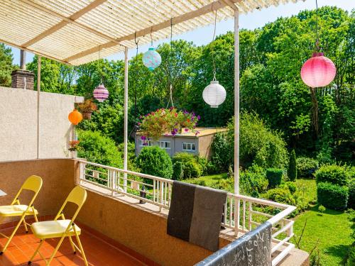 a balcony with chairs and lanterns and a house at rooms lux city in Luxembourg