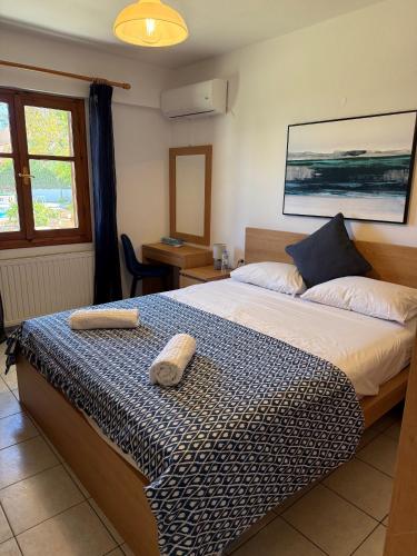 a bedroom with a bed with two towels on it at Villa Lemonia in Malia