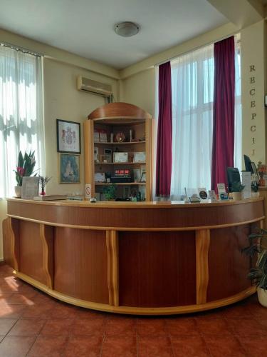 a law office with a large wooden reception desk at Hotel Slodes in Belgrade