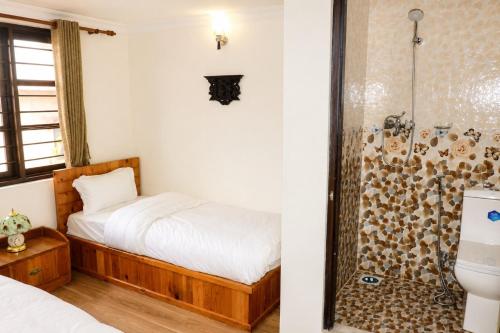 a bedroom with a bed and a shower at Birds Nest Hostel in Kathmandu