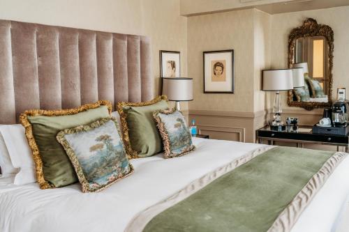 a bedroom with a large white bed with pillows at Althoff St James's Hotel & Club London in London