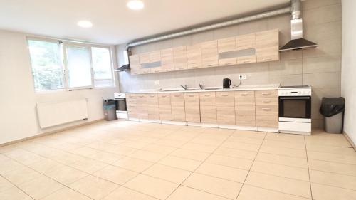 a large kitchen with white cabinets and appliances at Ubytování U Hráze in Liberec