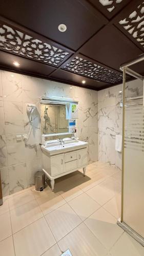 a bathroom with a sink and a mirror at Lanai Hotel فندق لاناي in Jeddah