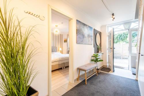 a hallway with a mirror and a bed in a room at Haus Breslauer Straße 22a in Süderende