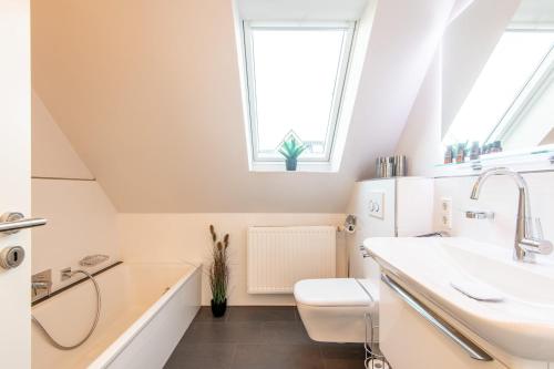 a bathroom with a sink and a toilet at Haus Breslauer Straße 22a in Süderende