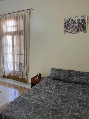 a bedroom with a bed and a window at Residence wafa 1 in Jijel