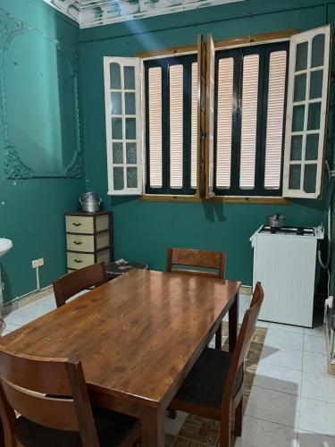 a dining room with a wooden table and chairs at Residence wafa 1 in Jijel