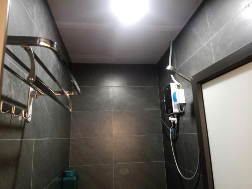 a bathroom with a shower with a light on the ceiling at Bản làng Home in Thanh Hóa