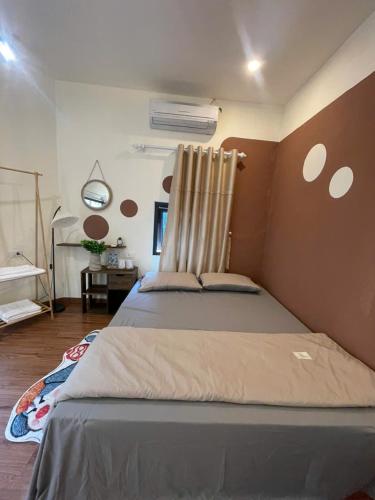 a bedroom with a large bed in a room at Bản làng Home in Thanh Hóa