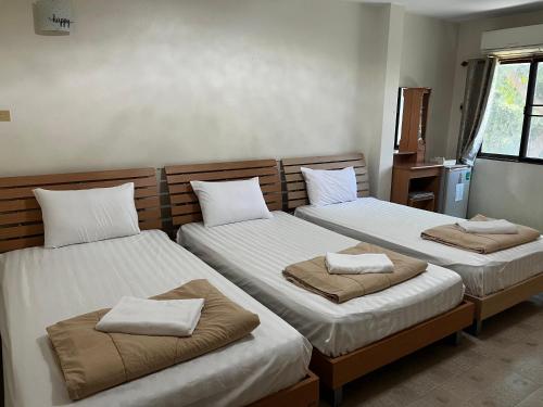 a bedroom with two beds with white pillows on them at Sky&Sea Guesthouse Cha am TK in Cha Am