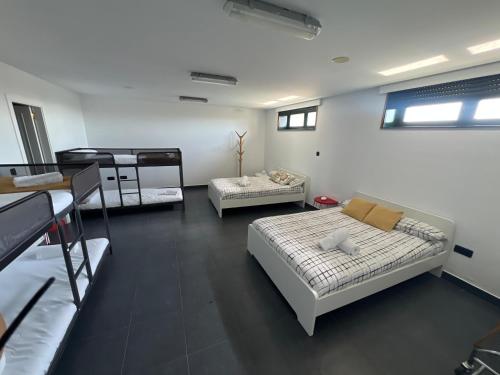 a room with two beds and two bunk beds at Pantin Beach View Villa Pool Aloha-te in Pantín