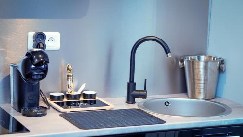 a kitchen counter with a coffee maker and a mixer at Love Room SPA l'impertinente in Isbergues
