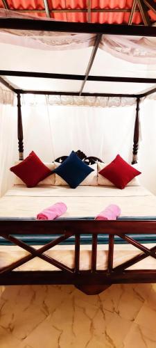 a bunk bed with several pillows on it at Freedom Life Yala in Tissamaharama