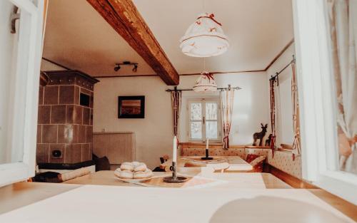 a living room with a fireplace and a sink at Stegerhütte in Hinterstoder