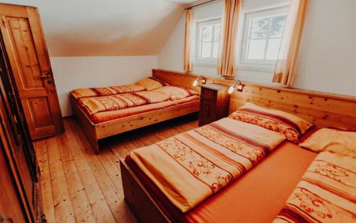 a bedroom with two beds and a window at Stegerhütte in Hinterstoder