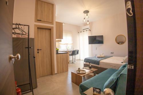 a bedroom with a bed and a living room at Saronic View Studio in Agioi Theodoroi