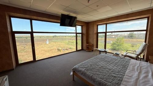 a bedroom with a bed and a flat screen tv at Смак Бажання in Sebino