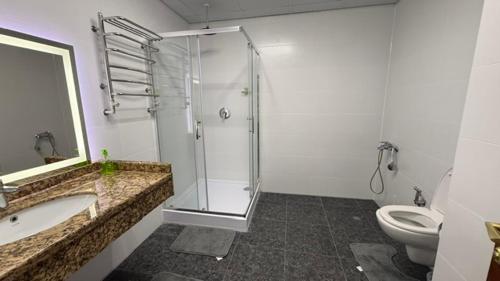 a bathroom with a glass shower and a toilet at Смак Бажання in Sebino