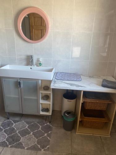 a bathroom with a sink and a mirror at The Tackroom in Fanore