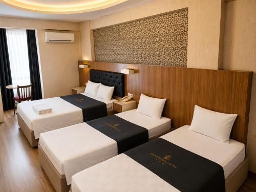 a hotel room with two beds in a room at Grand Mardin Hotel in Mersin