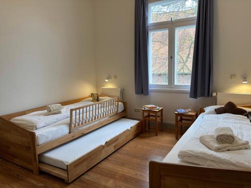 a bedroom with two beds and a window at Dahmerhof in Dahme