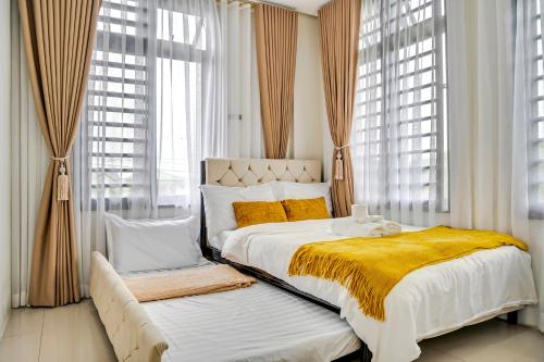 a bedroom with two beds with yellow blankets and windows at Casa Gomes Amuntay in Dasmariñas