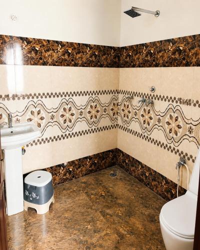 a bathroom with a toilet and a sink at The Nawab's Villa in Mānakpur