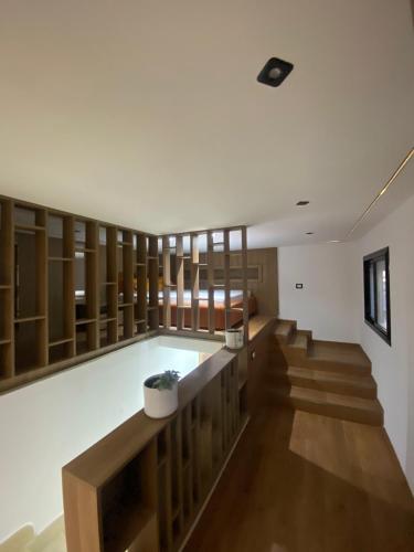 a room with wooden shelves and a swimming pool at Bouchareb résidences in Quşaybat al Madyūnī