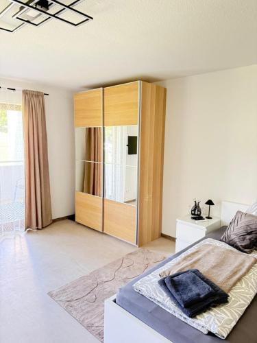 a bedroom with a bed and a wooden cabinet at Apartment Eppingen in Eppingen