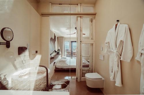 a bathroom with a sink and a toilet and a tub at Suites Daldeia - Suite 1 in Azueira