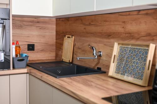 a kitchen with a sink and a counter top at Guesthouse Elsa in Ulcinj