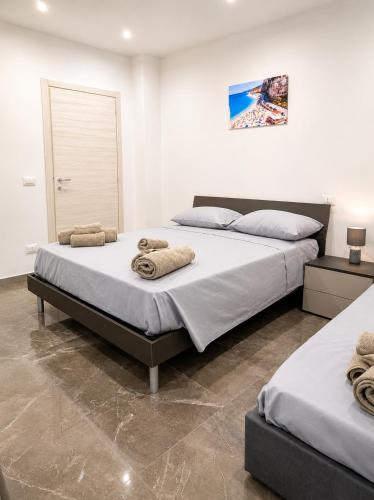 a bedroom with two beds with towels on them at I Due Moli 2'0 Vibo Marina in Vibo Valentia Marina