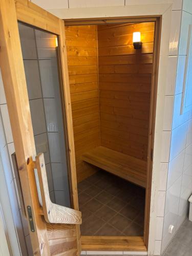a sauna with a bench in a room at Family Cabins in Fjæra