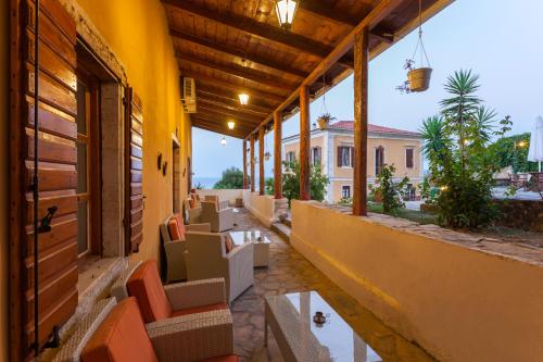 a balcony with chairs and tables on a building at Archontiko Maisonettes in Alykes