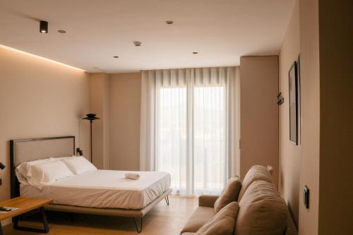 a living room with a bed and a couch at TeneaHome - Escuelas Pías in Yecla