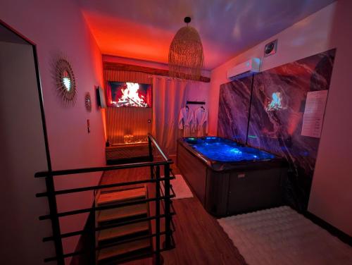 a bathroom with a jacuzzi tub in a room at Loveroom Romantique avec Spa et Secret Room - A proximité des Lacs - La Mure in La Mure