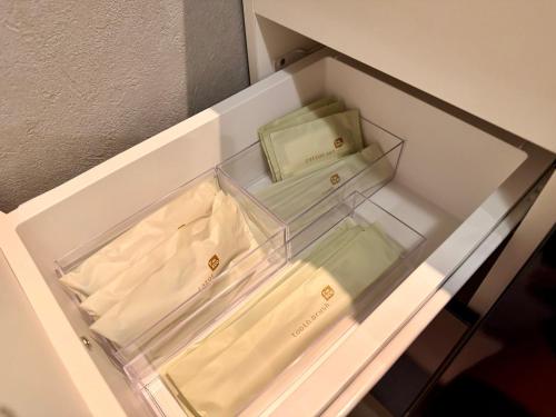 an open drawer with two boxes in it at Grand Opening SORA Yunokawa Penthouse in Hakodate