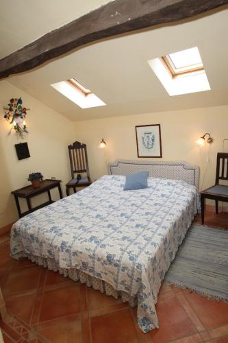 a bedroom with a bed with a laptop on it at Tenuta Guazzaura in Serralunga di Crea
