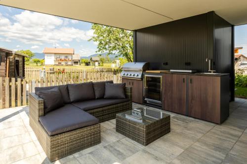 a living room with a couch and a kitchen at Hiša Urma in Celje