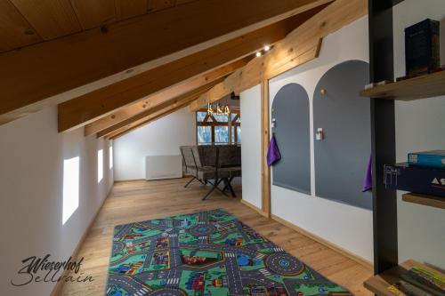 an attic room with a rug on the floor at Wieserhof Sellrain in Sellrain