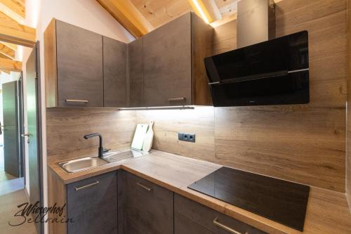 a kitchen with a sink and a microwave at Wieserhof Sellrain in Sellrain