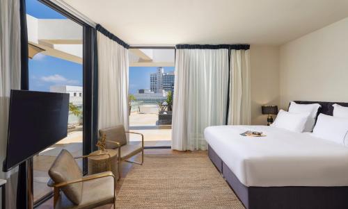 a hotel room with a bed and a balcony at Debrah Brown, a member of Brown Hotels in Tel Aviv