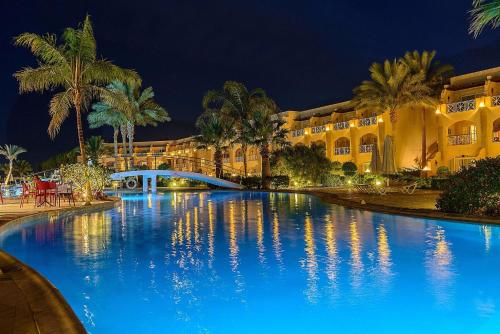 a large swimming pool in front of a building at PLM hotel Prima Life Makadi in Hurghada