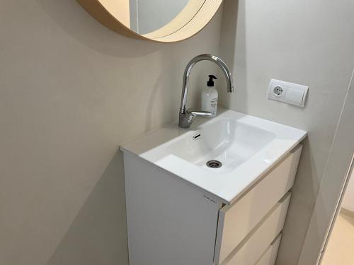 a bathroom with a white sink and a mirror at Es Pujols Vista Mare in Es Pujols