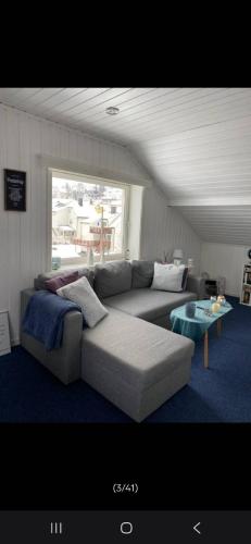 a living room with a couch and a table at Studio1 in Tromsø