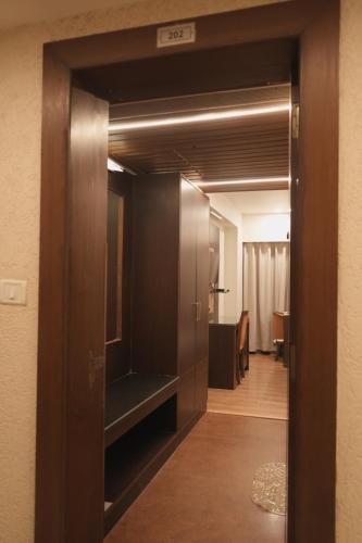 a hallway with an open door to a room at Hotel Rajhans Regent in Bhopal