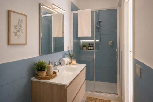 a bathroom with a sink and a shower at Villa Coccodrilla in Toscolano Maderno