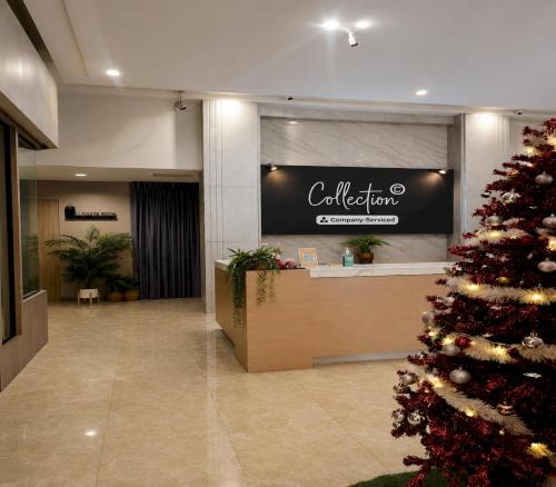 a christmas tree in the lobby of a hotel at Collection O Ayothaya Hotel in Phra Nakhon Si Ayutthaya