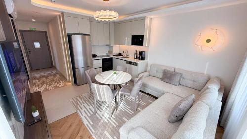 a living room with a couch and a table at Hiper Suites Residance in Antalya